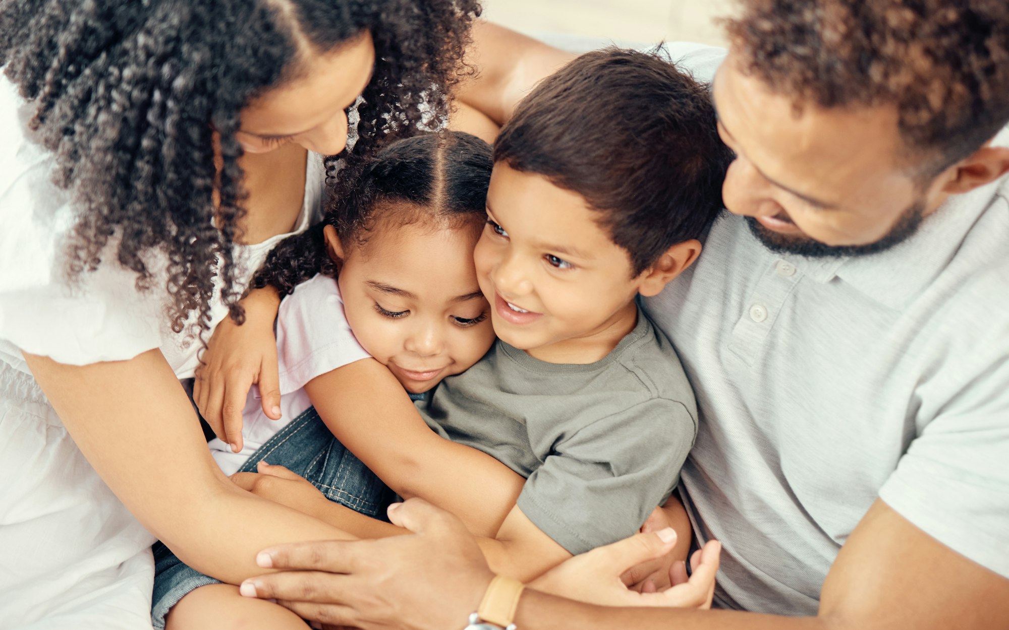 Relax, love and family hug for care in happy home together to show affection with young kids. Latin
