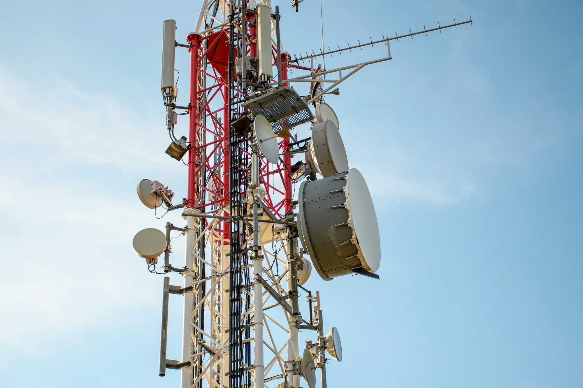 Low angle view of Antenna tower against a blue sky. 5g network cell tower.
